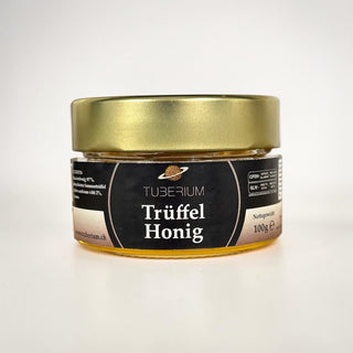 Trüffelhonig von Tuberium im 100-g-Glas mit goldenem Deckel und schwarzem Etikett.